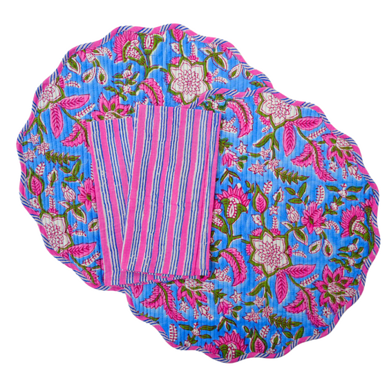 Image showing hand block printed reversible placemats and striped napkins, crafted from organic cotton in Jaipur. Quilted design adds texture and durability. Ethically made by family-run ateliers, showcasing traditional craftsmanship. Floral pattern on one side and elephant pattern on the other, both printed by hand